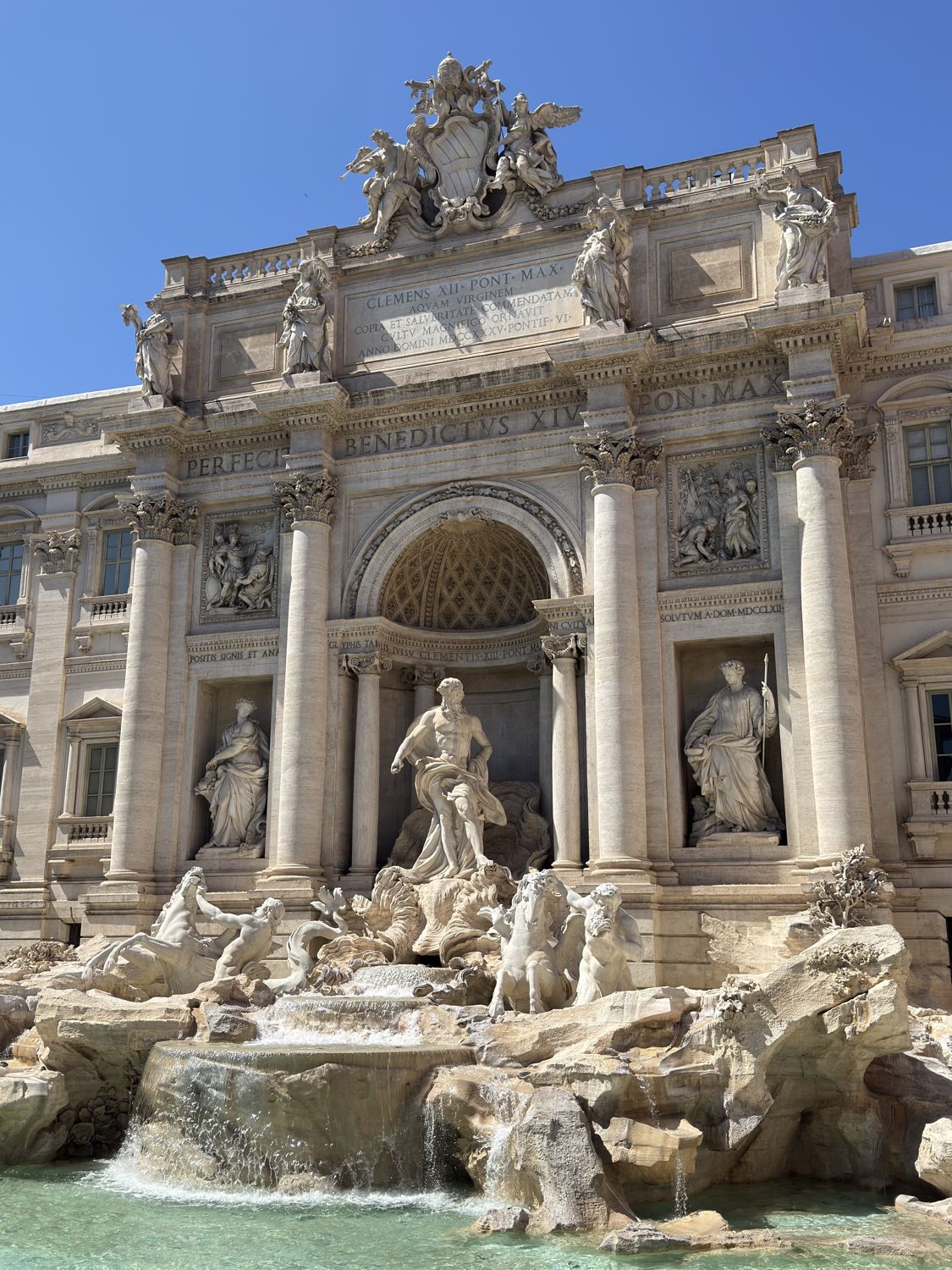 The Trevi Fountain in Rome under a clear blue sky